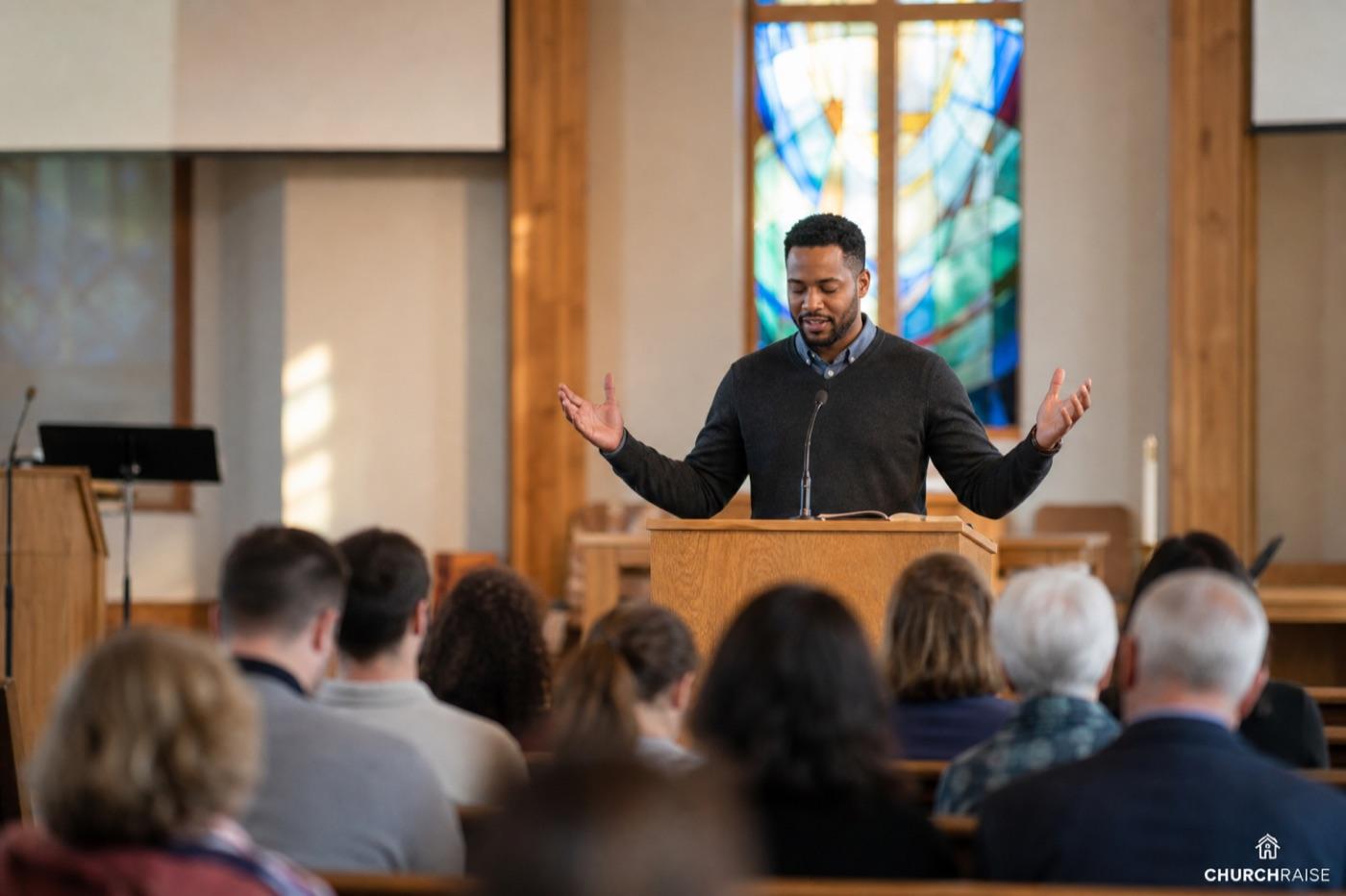 Pastor giving a benediction blessing at the end of a Sunday church service